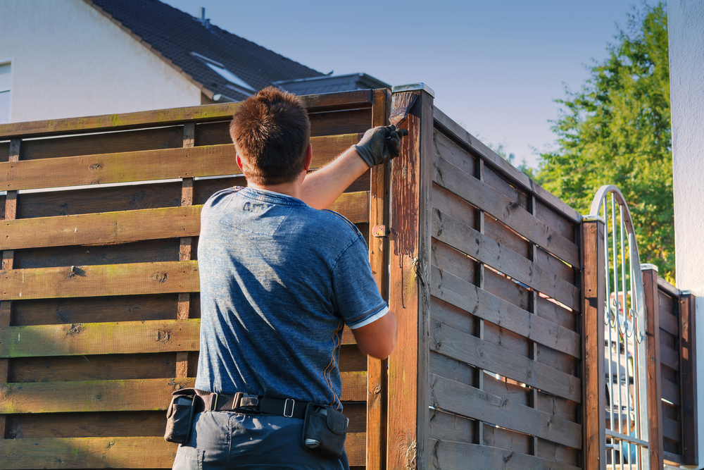 a man buildinng a fence